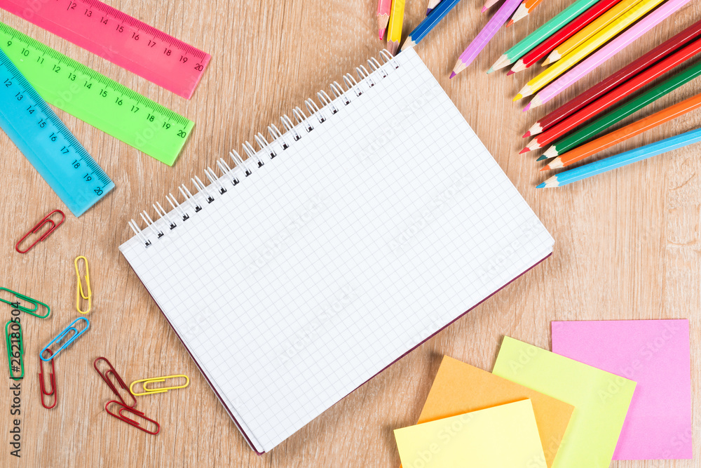 Idea of school still life with pencils and notebook on desk