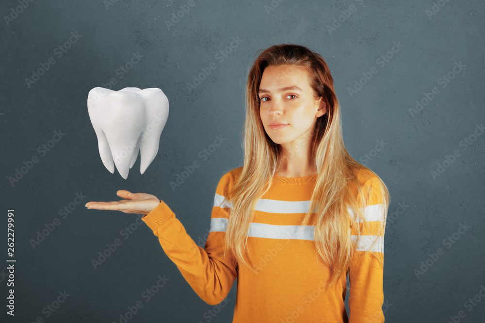 Dental care, tooth on hand