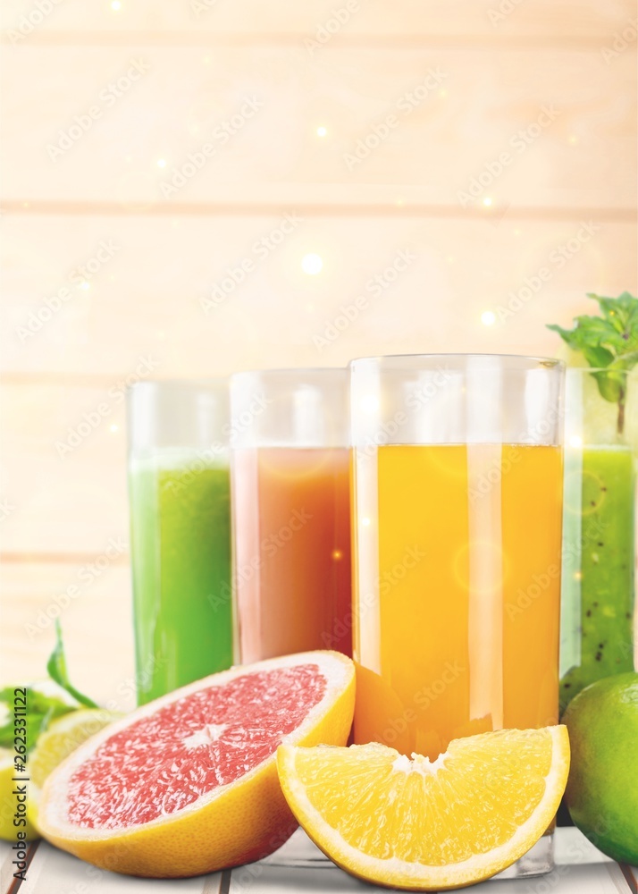 Tasty fruits  and juice with vitamins on background