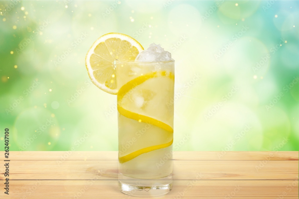 Lemonade with fresh lemon on  background