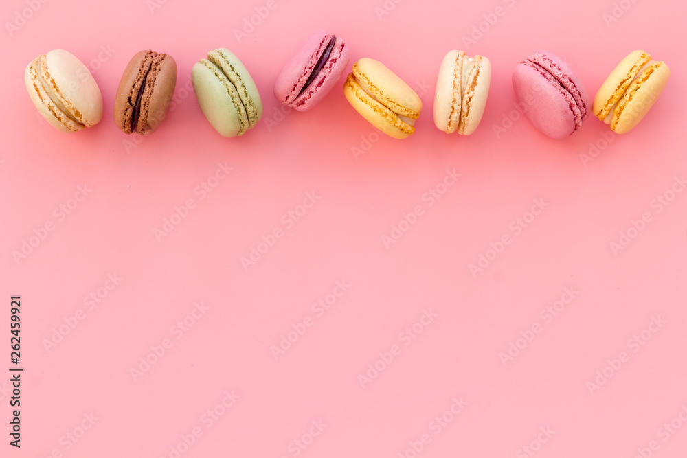 Macarons design on pink background top view space for text