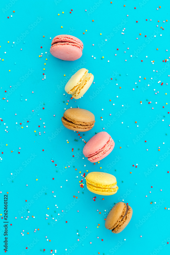 Macarons design on blue background top view space for text