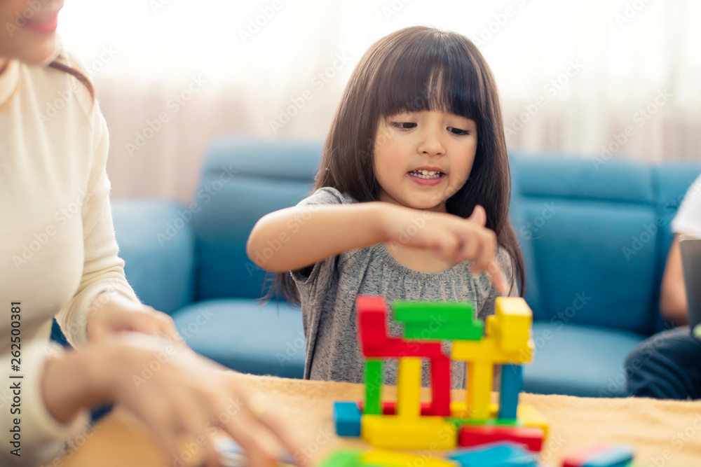 happy family caucasian and asian mixed race with pretty daughter enjoy family time with toy  togethe