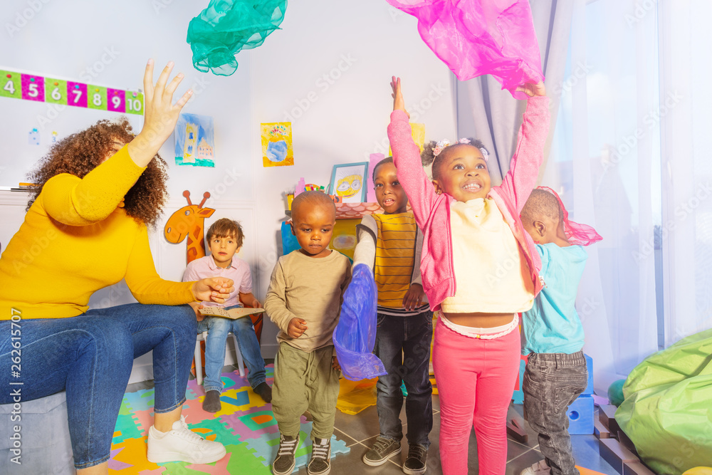 kids play game and throw handkerchief in the air