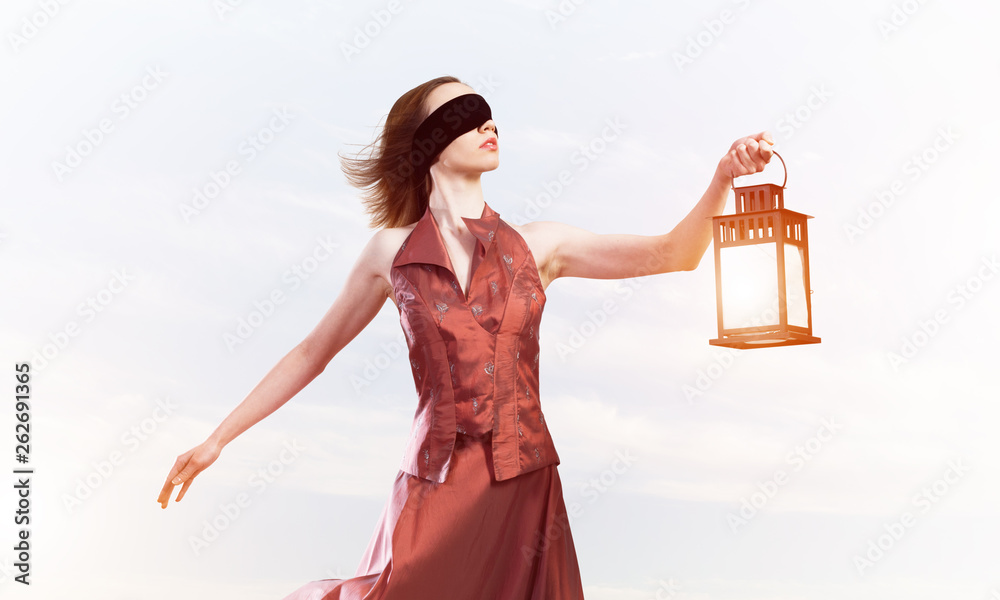 Attractive girl muse with old lantern in hand at summer day