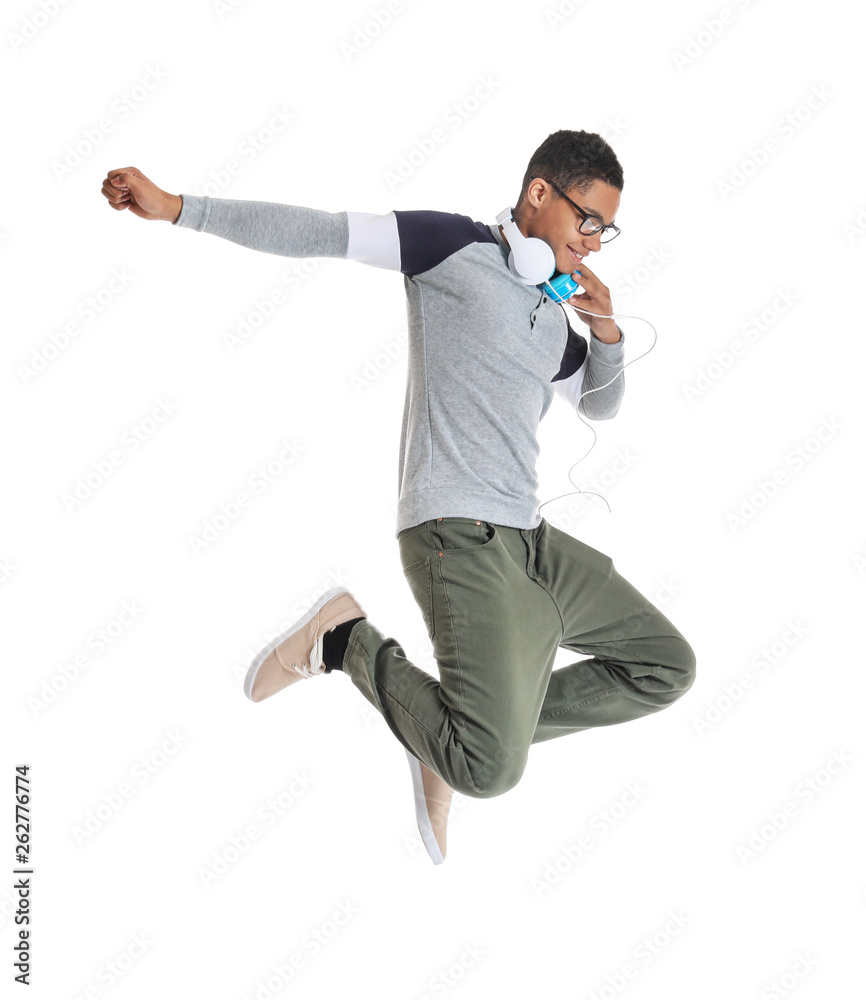 Portrait of jumping African-American teenage boy on white background