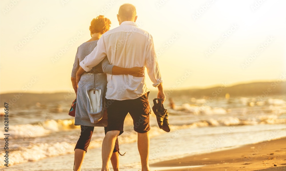 Close-up portrait of an elderly couple hugging on seacoast