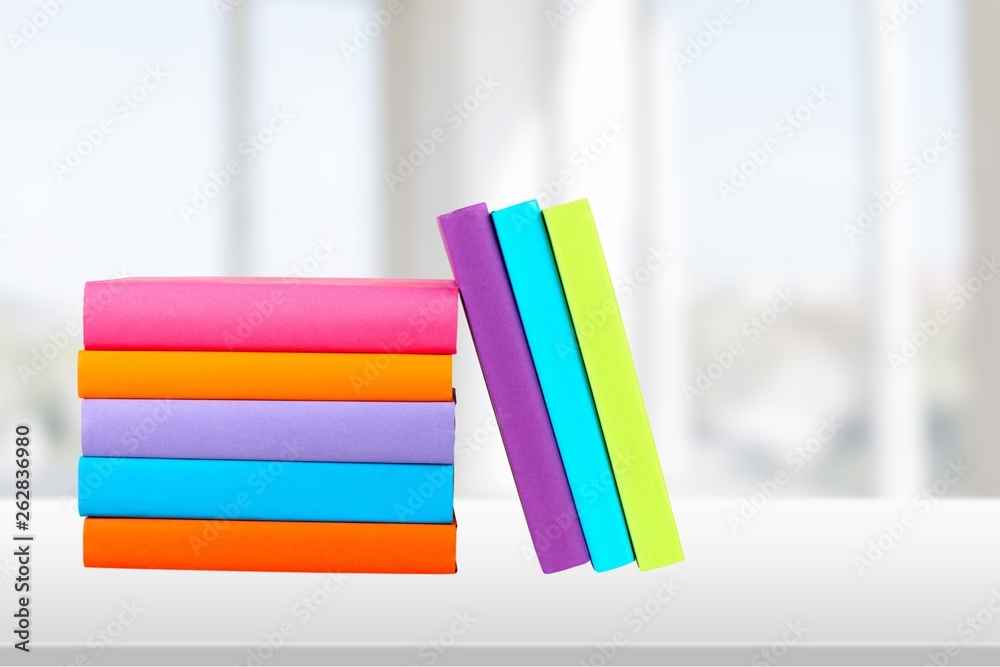 Colorful books collection on background.