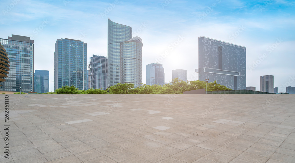 Empty square tiles and skyline of urban buildings..