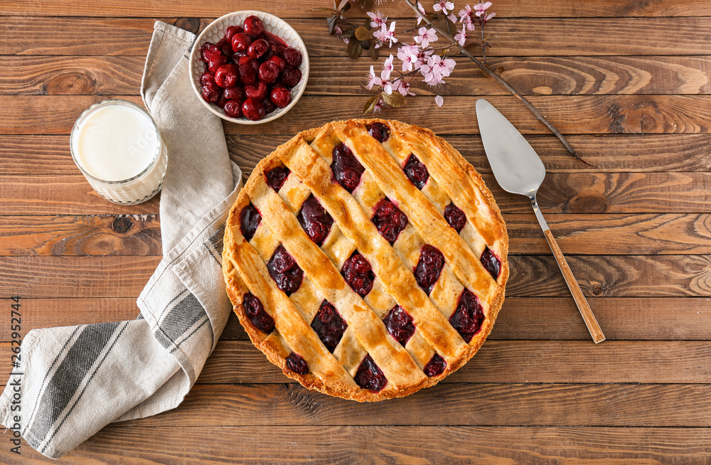 Composition with tasty cherry pie on wooden table