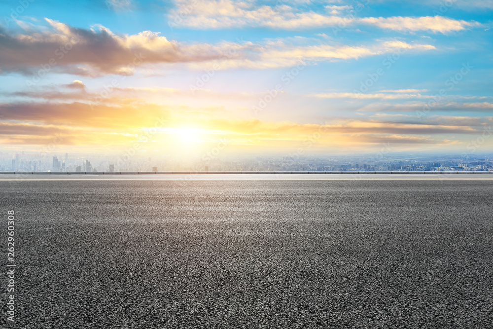 Shanghai city skyline and empty asphalt road ground scenery at sunrise