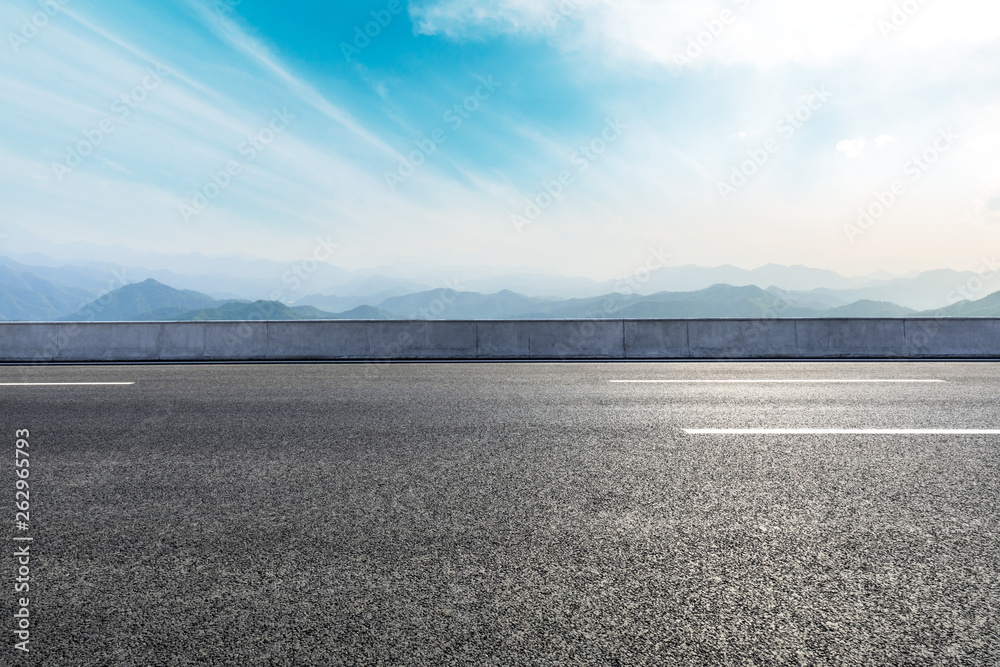 Empty asphalt road and mountains with beautiful clouds landscape