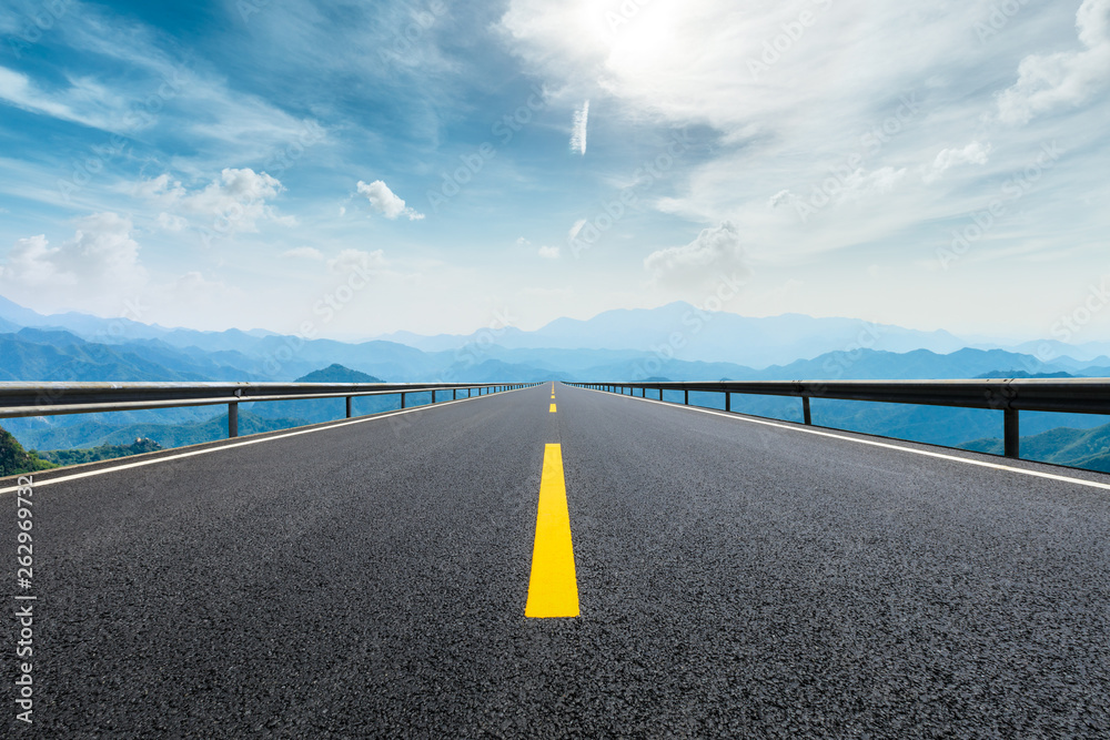 Empty asphalt road and mountains with beautiful clouds landscape