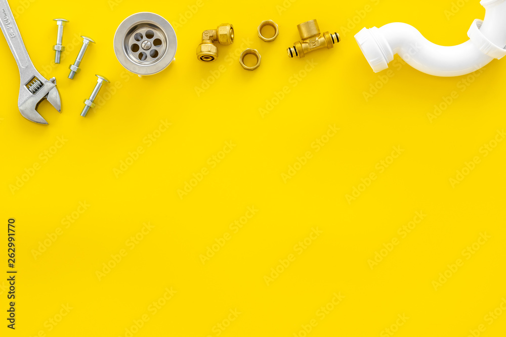 Plumber profession with gear and instruments for repair tubes on yellow background top view copyspac