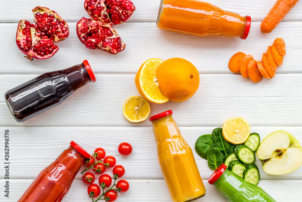 vegetable and fruit juice in bottles for diet drink on white wooden background top view mock up