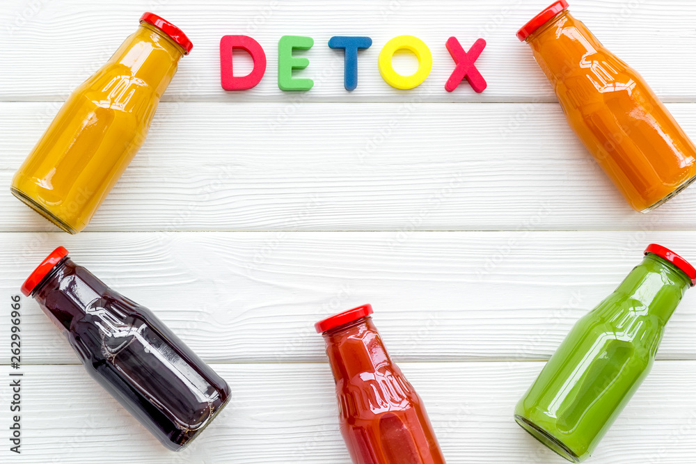 bottles with fresh carrot, tomato, apple, cucumber, lemon, pomegranate juices on white background to