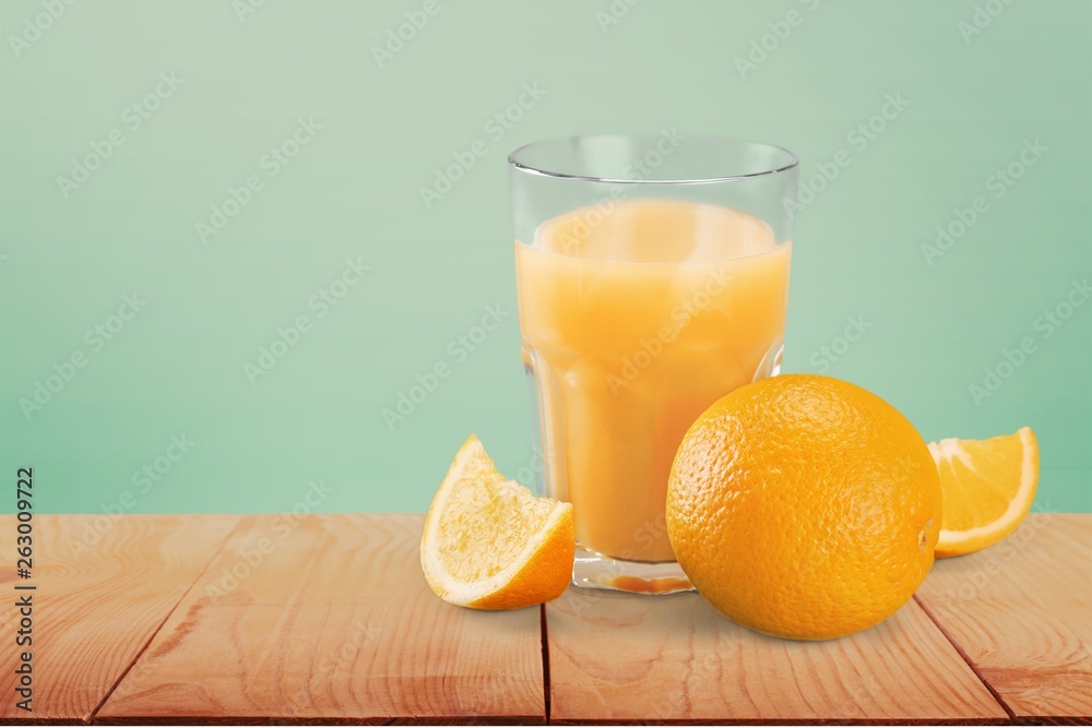 Orange juice and slices of orange on background