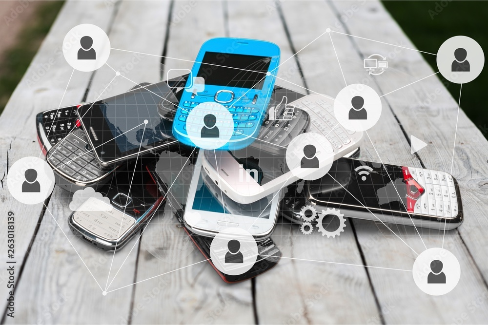 Pile of old smartphones on wooden background