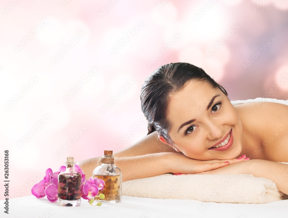 Beautiful young woman relaxing with massage at beauty spa