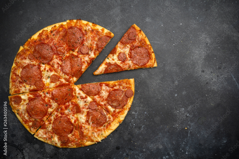 Italian pizza pepperoni on dark stone background