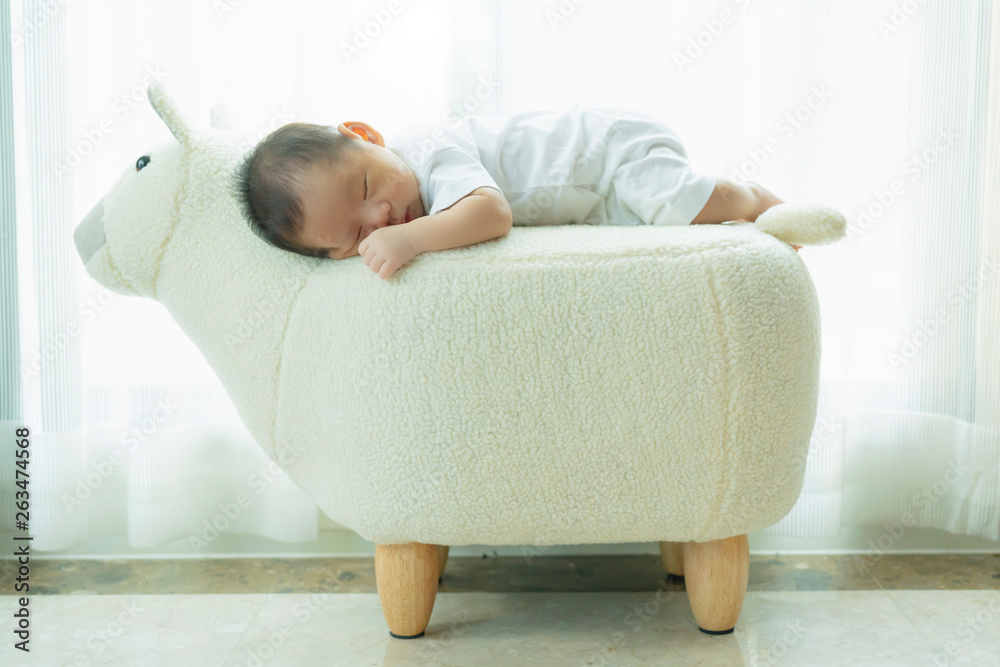 cute infant baby boy sleep with sweet dream and peaceful white soft bed