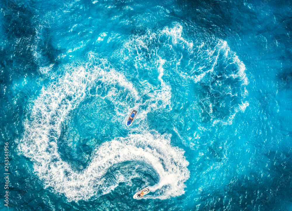 Aerial view of floating water scooter in blue water at sunset in summer. Holiday in Indian ocean, Za