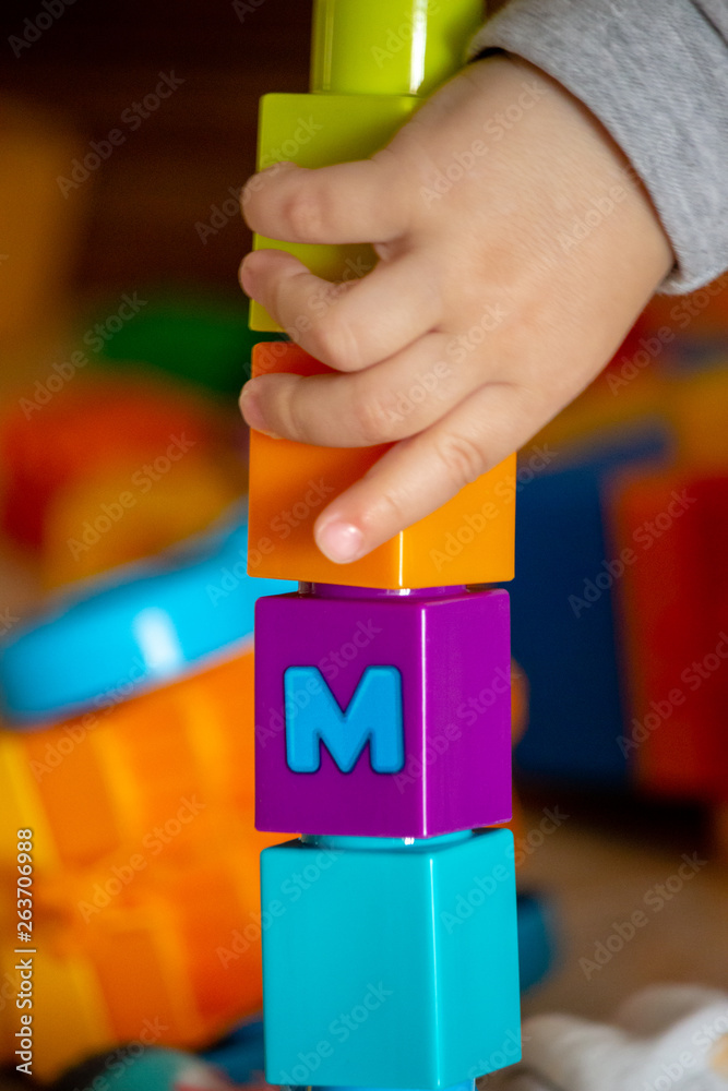 child playing with plastic blocks	