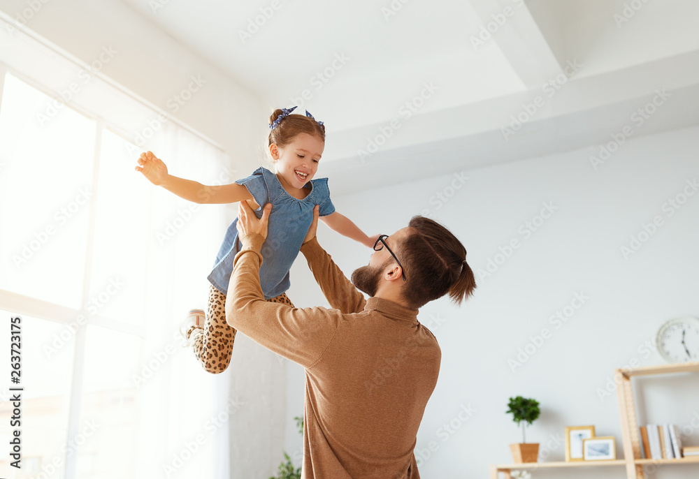 Fathers day. Happy family daughter hugs his dad  .