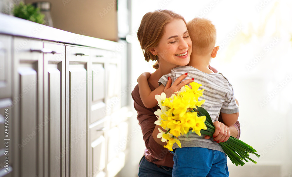 happy mothers day! child son gives flowersfor  mother on holiday .