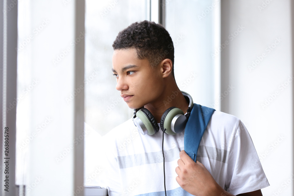 Portrait of African-American teenage boy near window