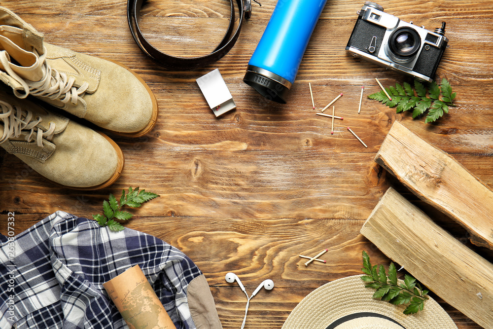 Set of items for tourist on wooden background