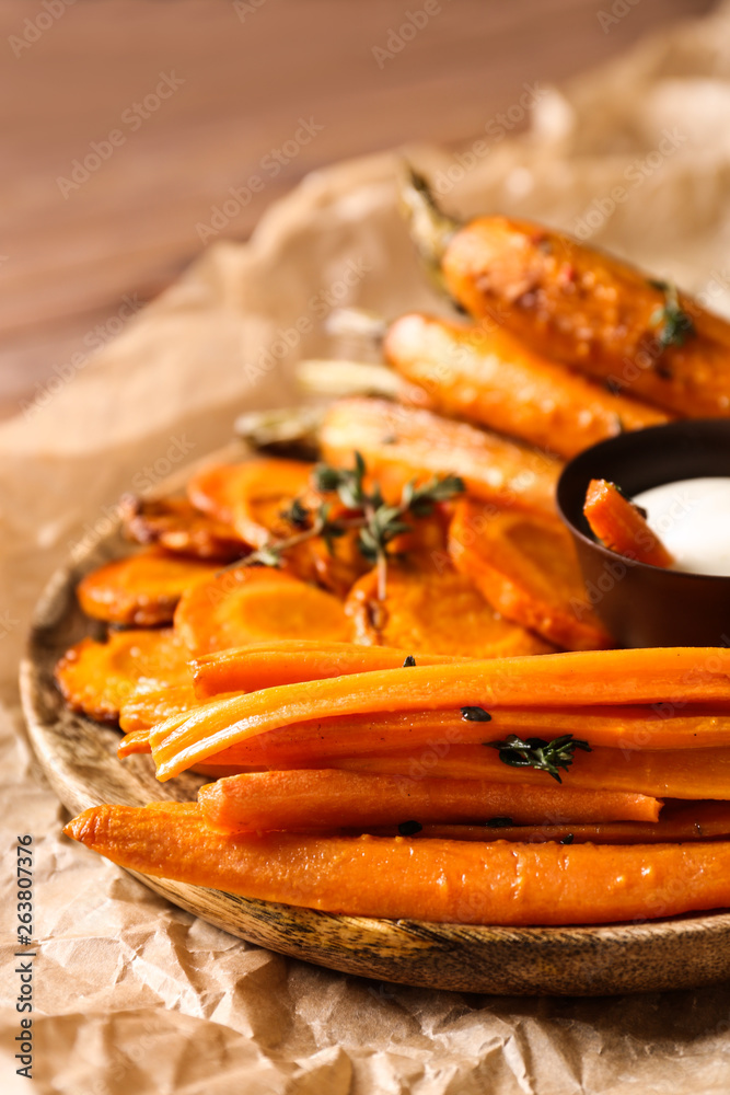 Plate with cooked carrot on table, closeup