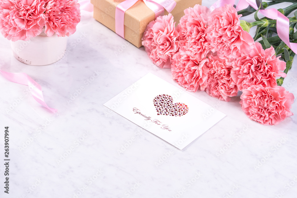 Design concept - Beautiful bunch of carnations on marble white background, top view, copy space, clo