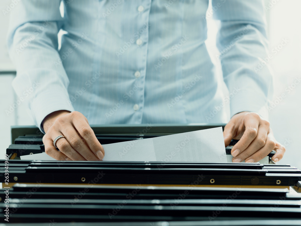 Office worker searching files in the archive