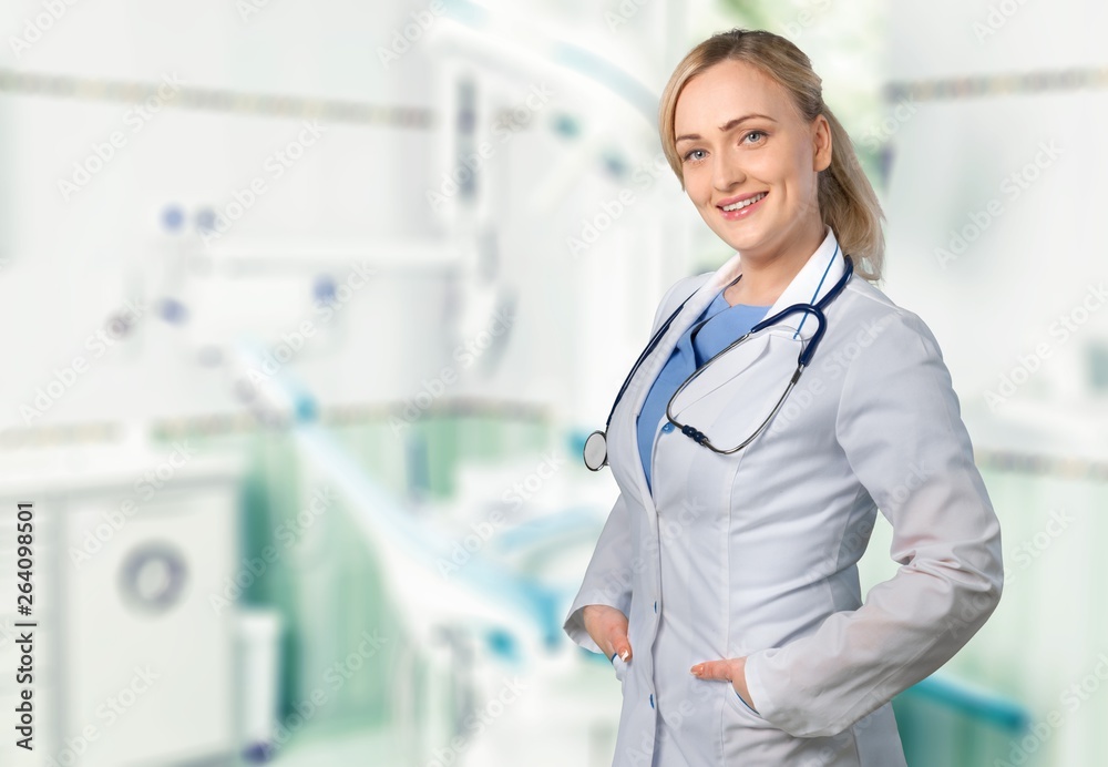 Handsome doctor with stethoscope smiling at camera