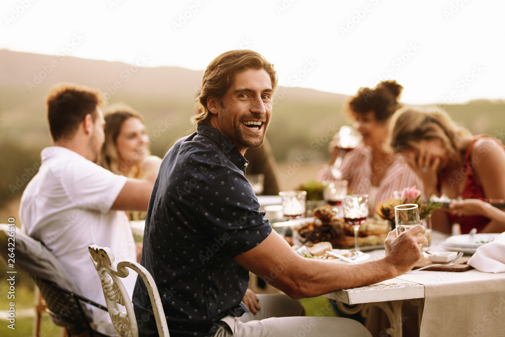 Young guy enjoying at outdoor party with friends