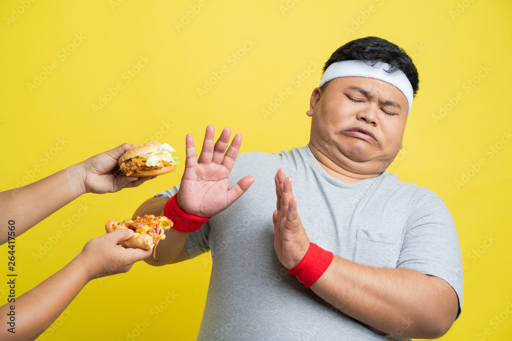 Fat men refuse to eat pizza and hamburgers.