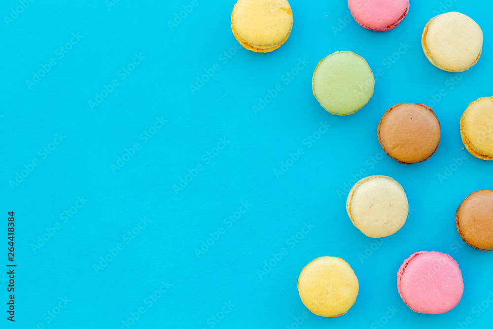 sweet dessert pattern with macarons on blue background flat lay mockup