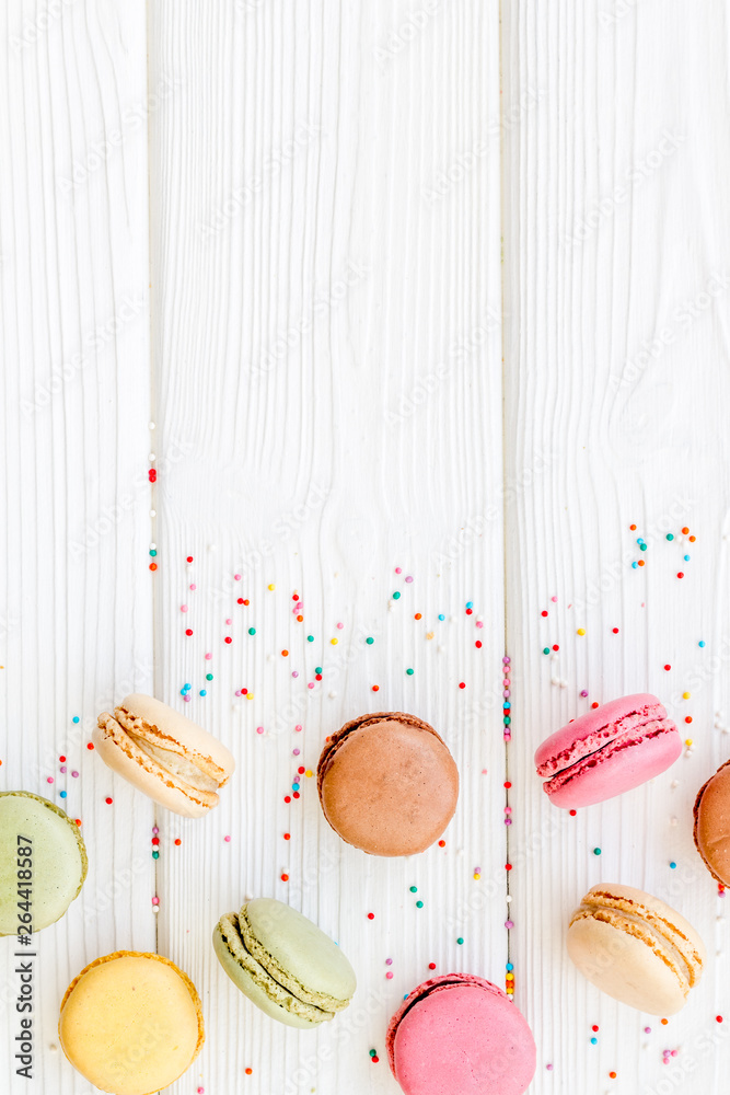 sweet dessert pattern with macarons on white wooden background flat lay mockup