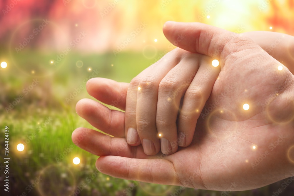 Hands of man and woman holding together over background