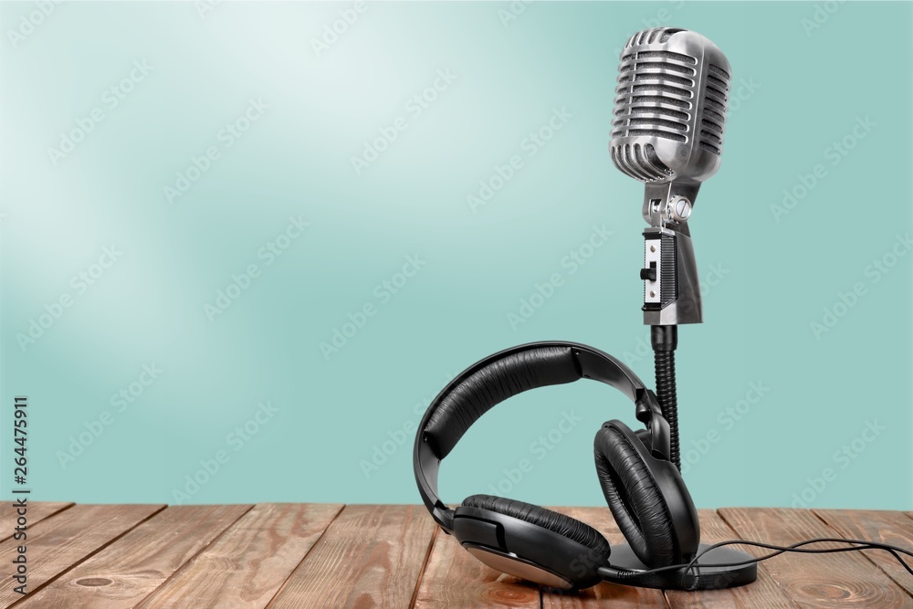 Retro style microphone and headphones on  background