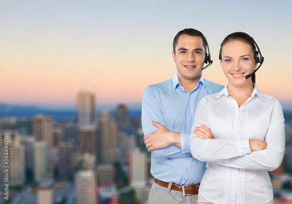 Confident young Business couple with crossed hands on background