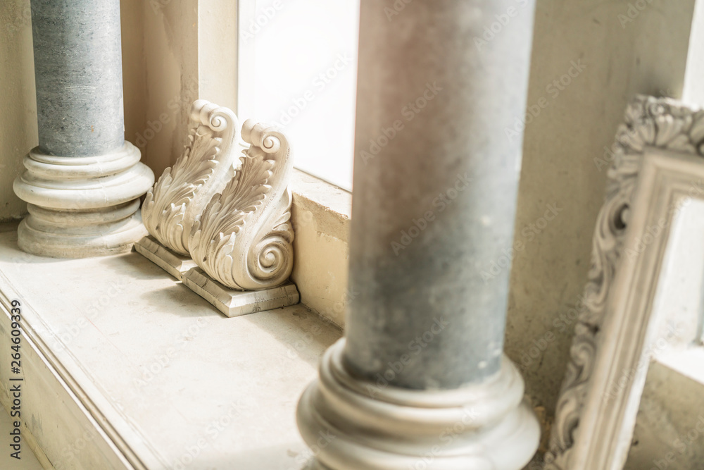 close up old concrete decorate ornament column with morning light from window