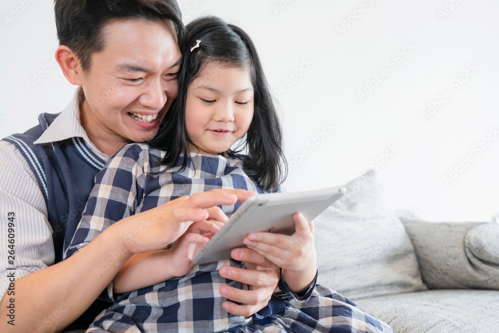 happiness asian family weekend vacation with mom dad daughter stay together use tablet and laptop ho