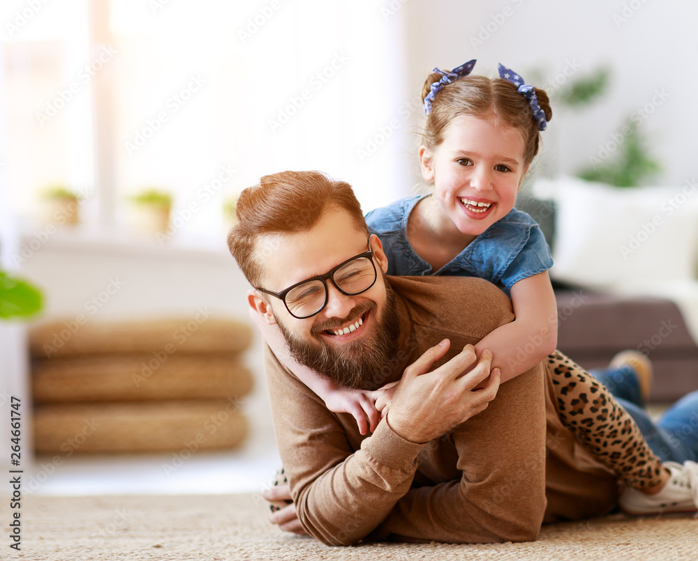 Fathers day. Happy family daughter hugs his dad  .