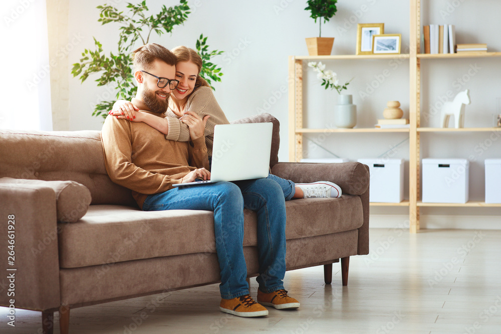 happy couple with laptop computer at home  .