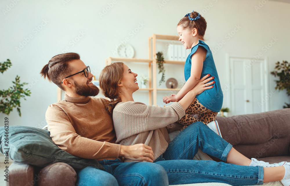 happy family mother father and child daughter laughing   at home  .