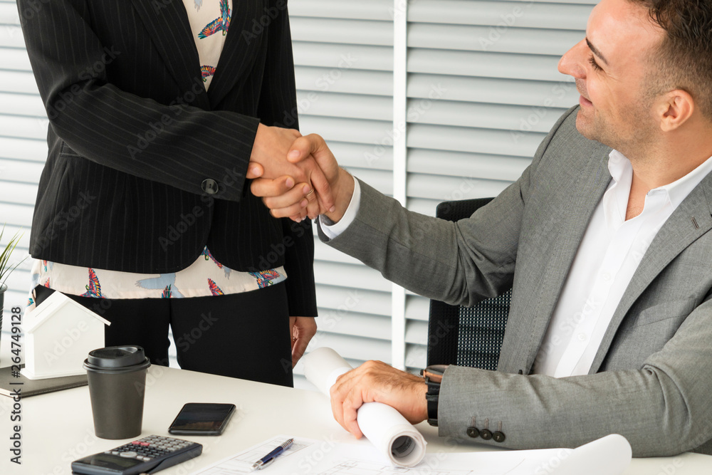 Businessman executive handshake with businesswoman worker in modern workplace office. People corpora