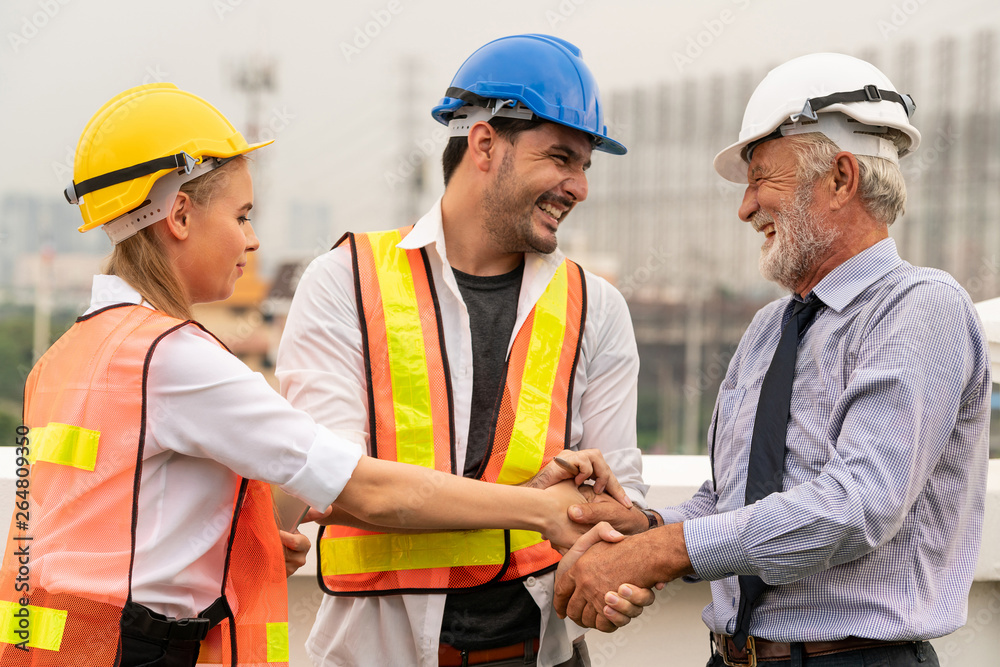 Engineer, architect and business man working on the engineering project at construction site. House 