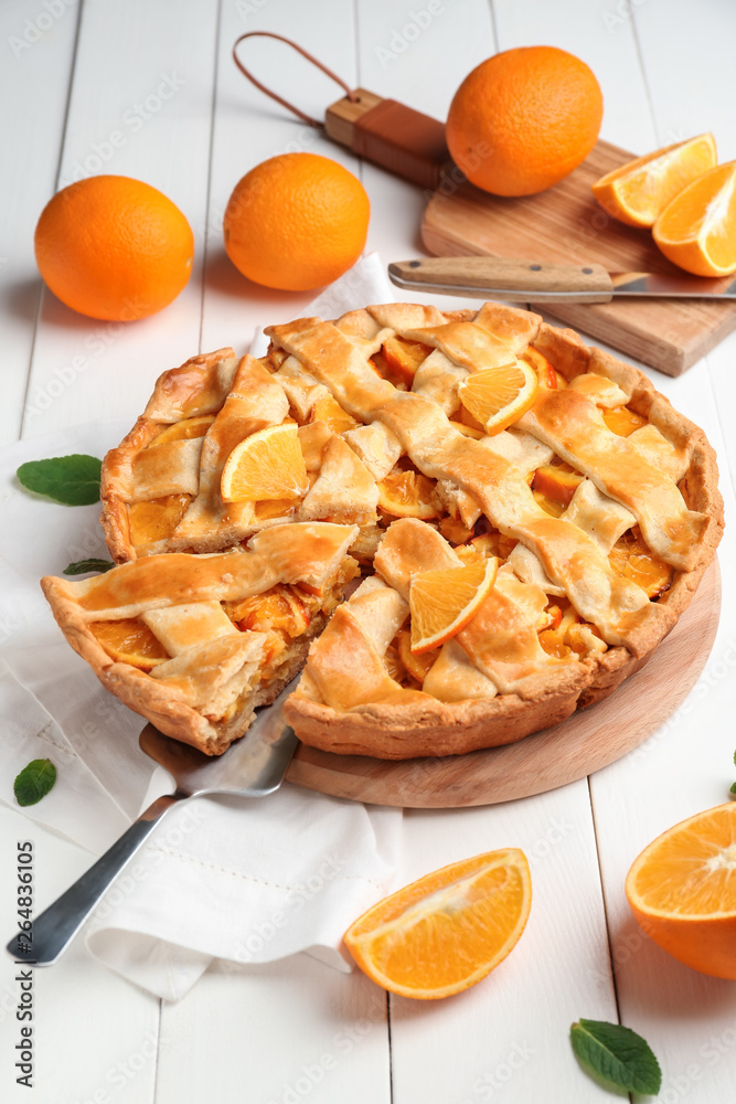 Tasty orange pie on table